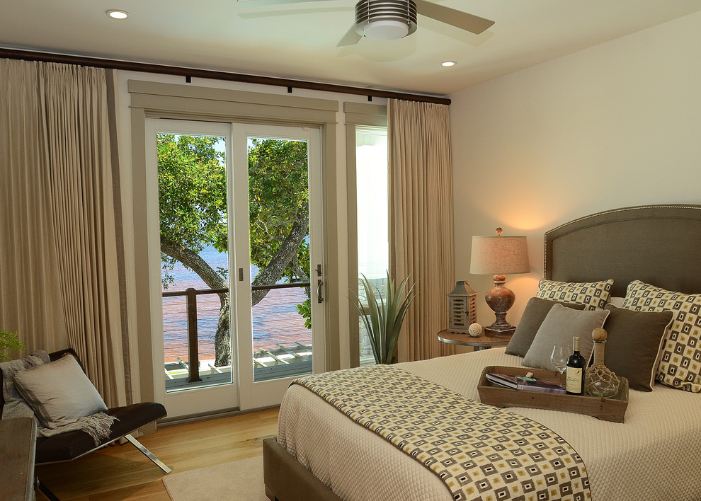 Example of a large trendy guest light wood floor bedroom design in Miami with white walls and no fireplace