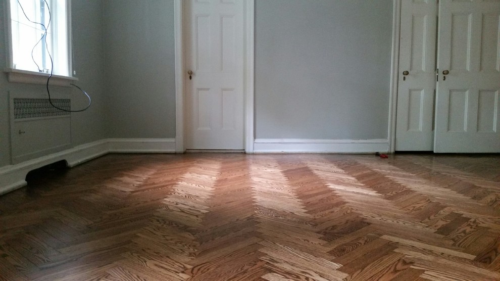Photo of a large classic master bedroom in St Louis with grey walls, medium hardwood flooring and brown floors.