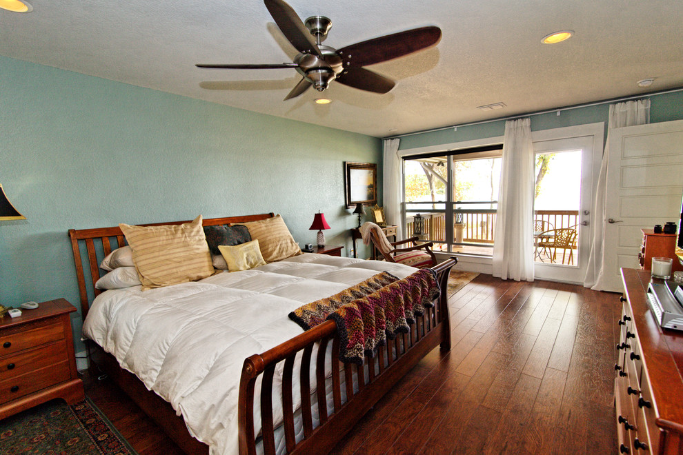 Medium sized traditional master bedroom in Dallas with blue walls and medium hardwood flooring.
