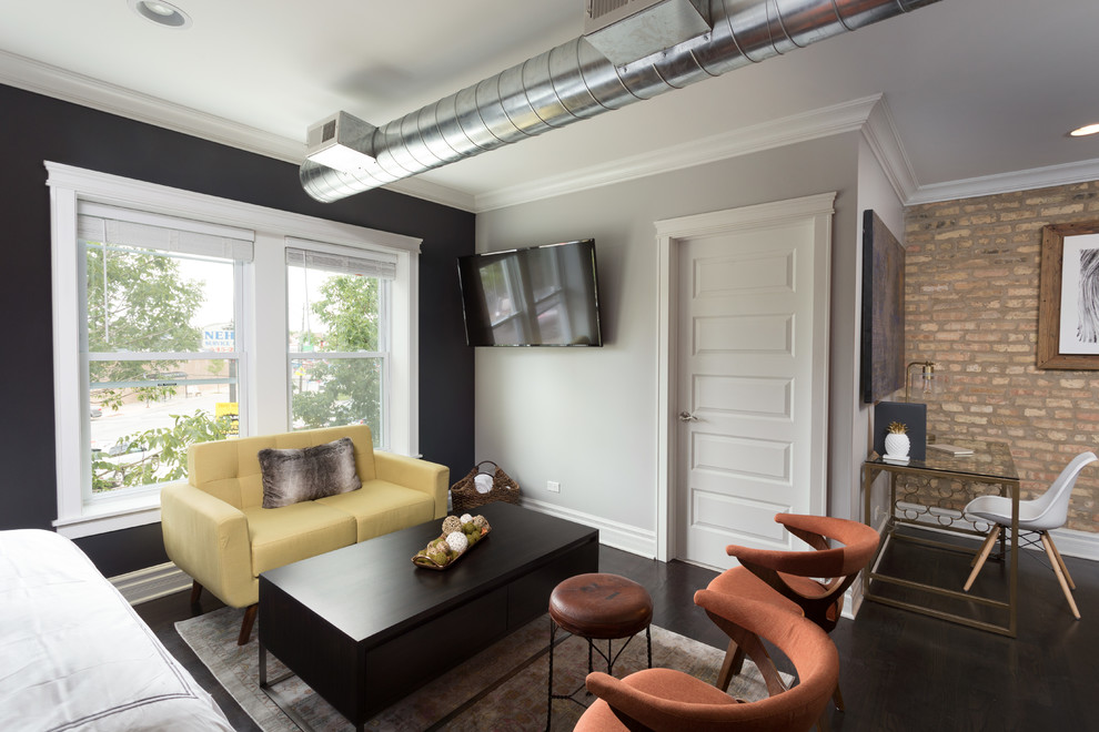 This is an example of a medium sized urban guest bedroom in Chicago with multi-coloured walls, dark hardwood flooring, no fireplace and grey floors.
