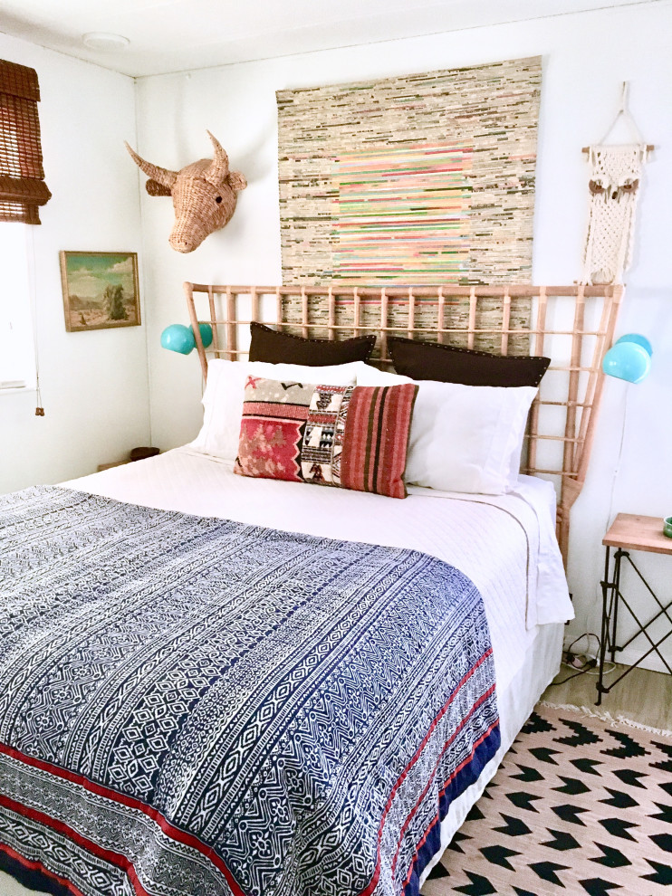 Photo of a medium sized bohemian master bedroom in Los Angeles with white walls, vinyl flooring and grey floors.