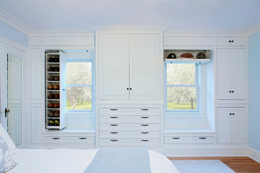 Bedroom - traditional medium tone wood floor bedroom idea in New York with blue walls