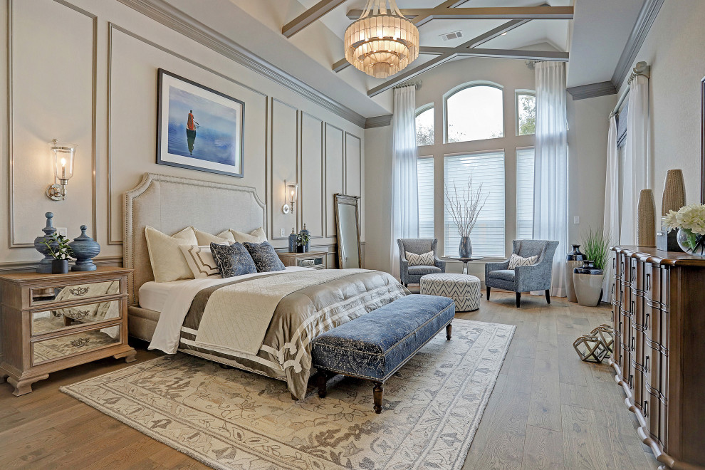 Photo of a large classic master bedroom in Houston with grey walls, medium hardwood flooring, no fireplace, brown floors, a vaulted ceiling and wainscoting.