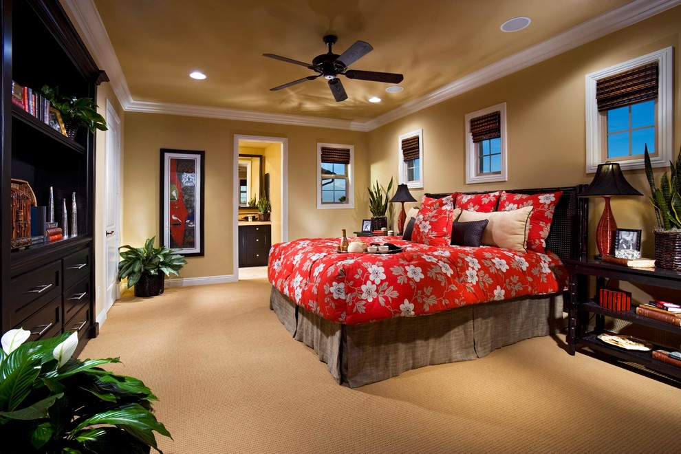 Design ideas for a master bedroom in Orange County with yellow walls, carpet and no fireplace.