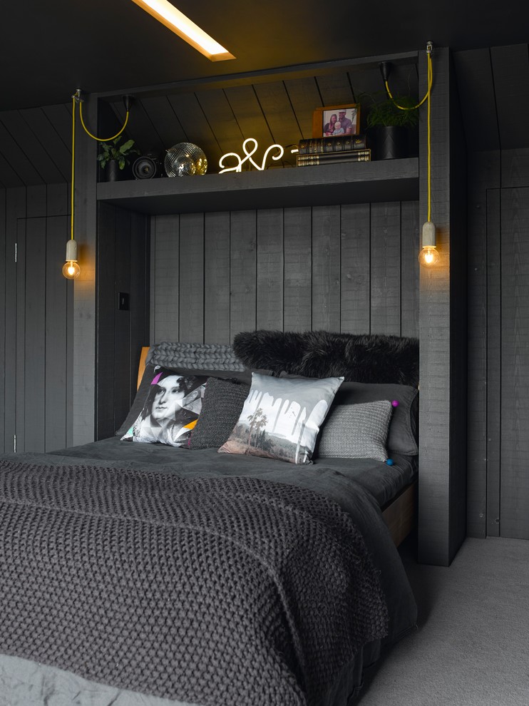 Design ideas for a bohemian grey and black bedroom in London with carpet, grey floors and black walls.
