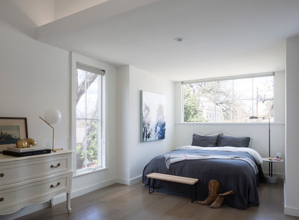 This is an example of a traditional master bedroom in Austin with white walls.