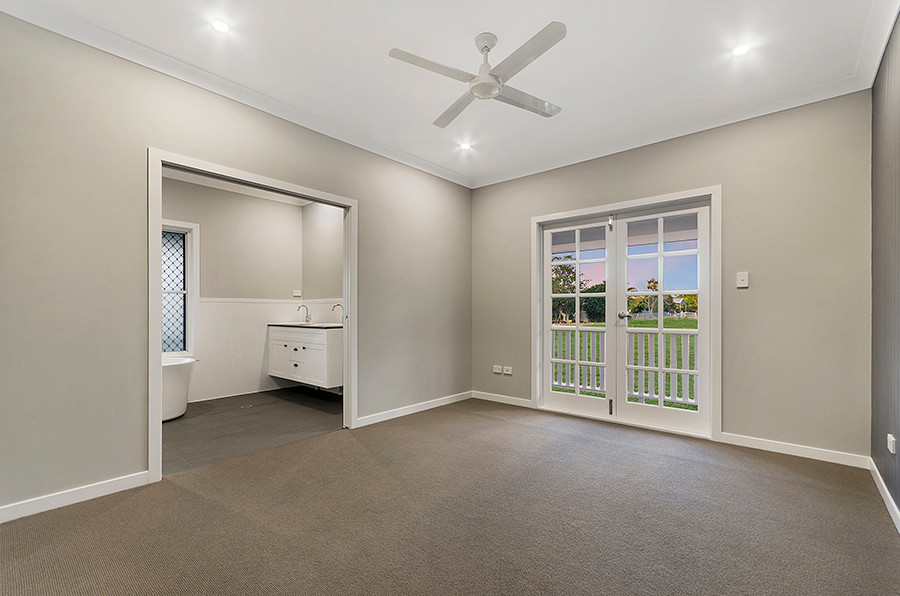 Photo of a contemporary master bedroom in Townsville with grey walls, carpet and grey floors.