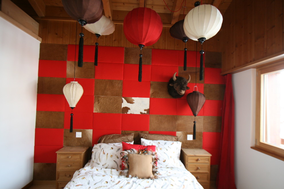 This is an example of a medium sized eclectic guest bedroom in Other with red walls and medium hardwood flooring.