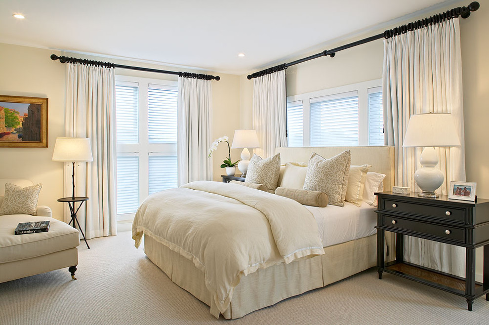 Elegant carpeted bedroom photo in New York with beige walls