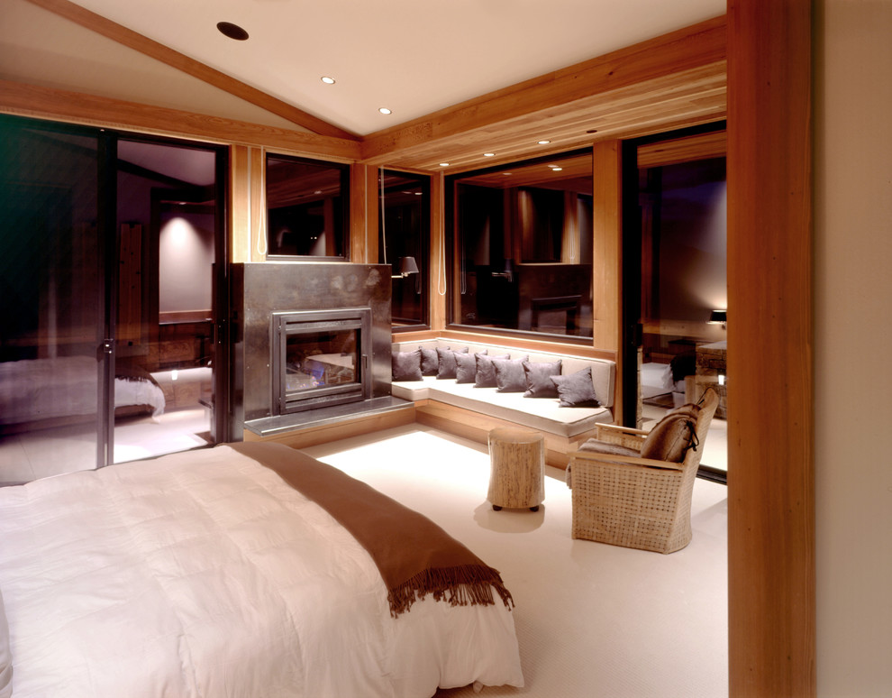 Inspiration pour une chambre minimaliste avec une cheminée standard et un manteau de cheminée en métal.