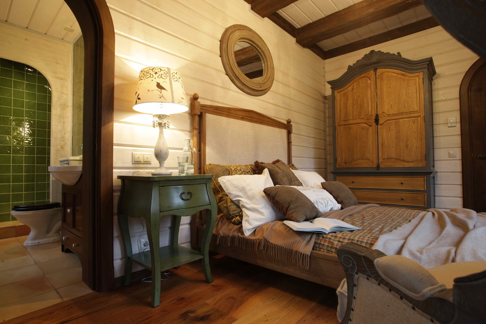 Example of a mid-sized mountain style guest medium tone wood floor bedroom design in Moscow with white walls