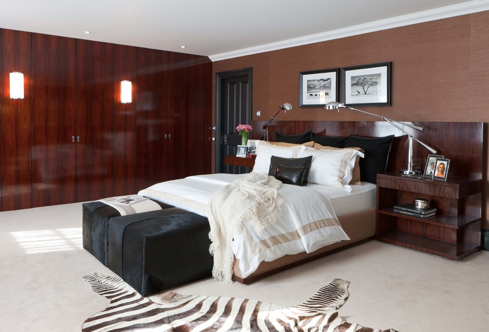 Inspiration for a modern bedroom in London with brown walls and carpet.