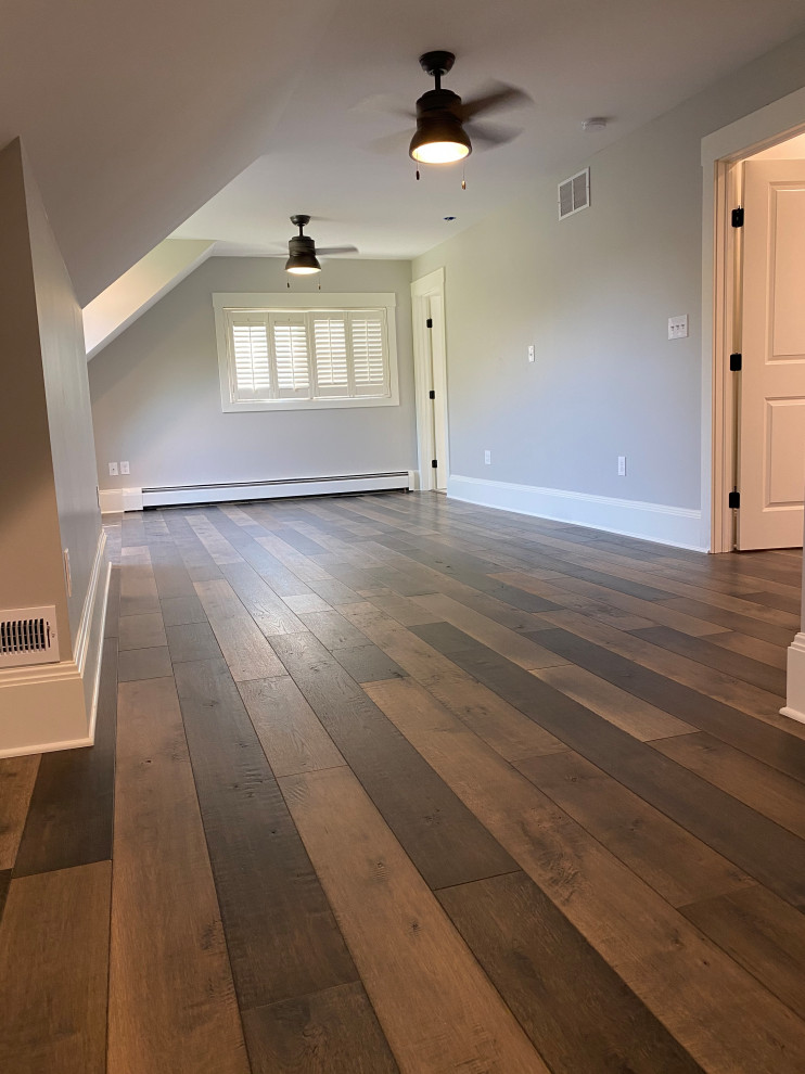 Farmhouse master bedroom in Cleveland with grey walls and medium hardwood flooring.
