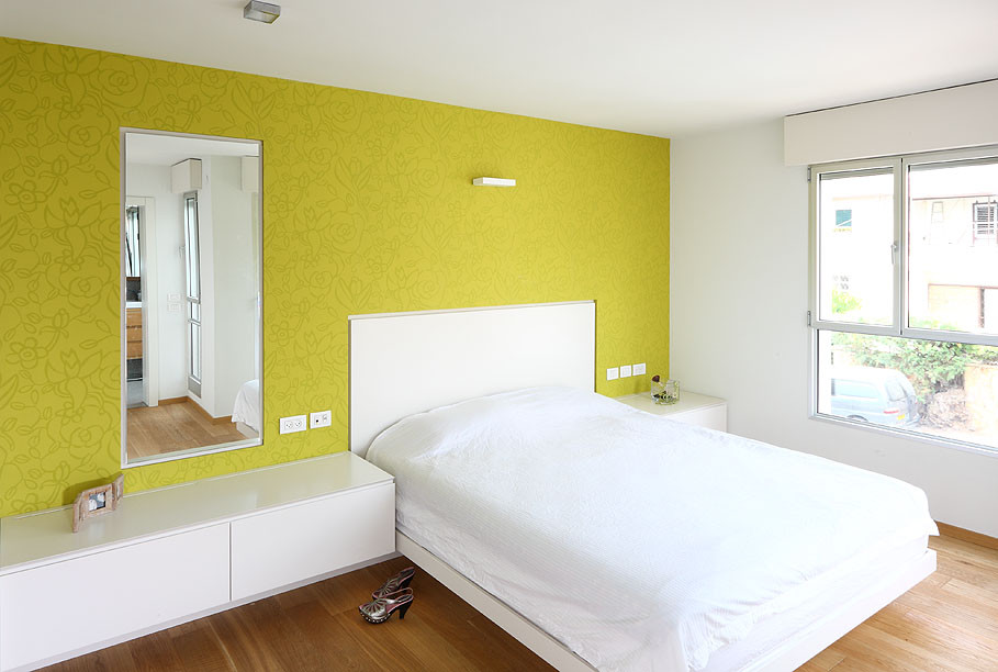 Exemple d'une petite chambre parentale moderne avec un mur vert, un sol en bois brun et aucune cheminée.