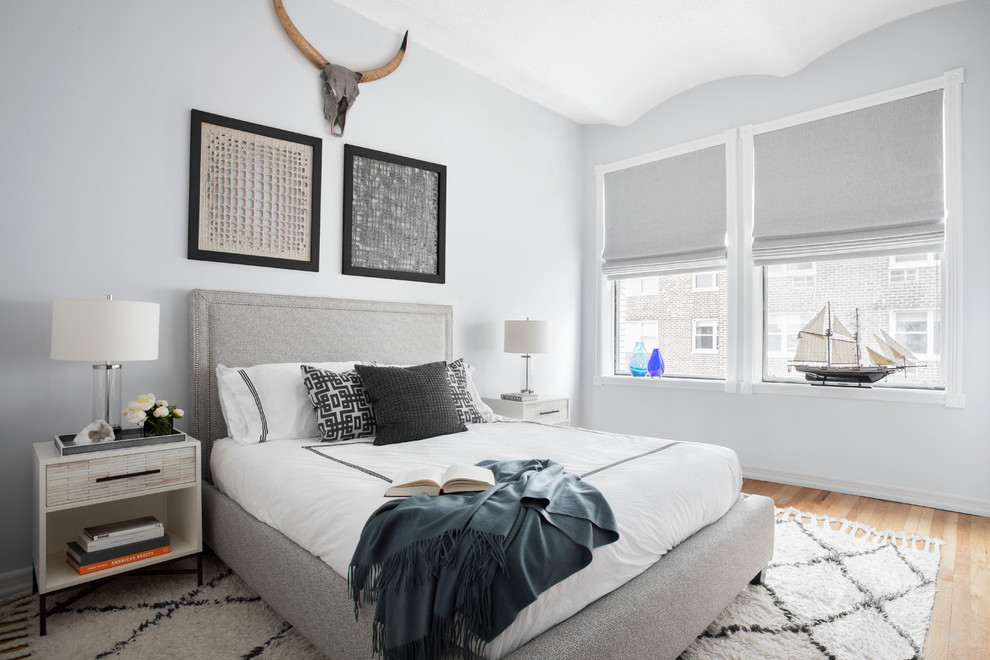 Esempio di una camera da letto stile marinaro con pareti grigie e parquet chiaro