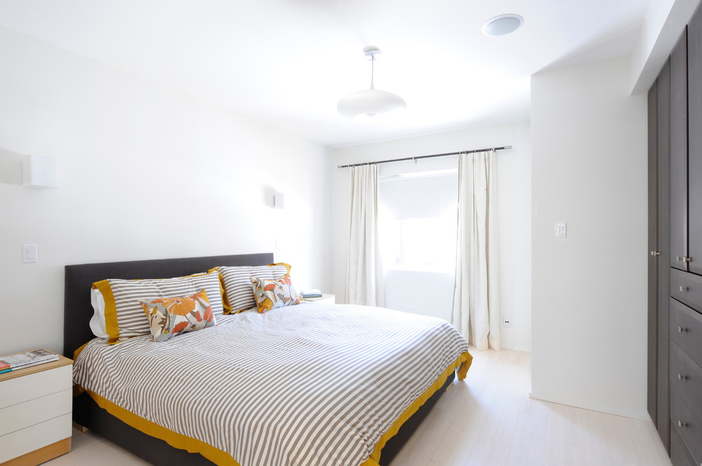 Photo of a medium sized scandi master bedroom in Ottawa with white walls and light hardwood flooring.