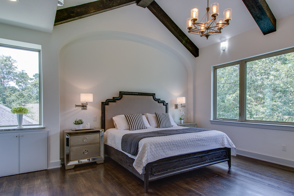 Large rustic master bedroom in Houston with white walls, dark hardwood flooring and no fireplace.