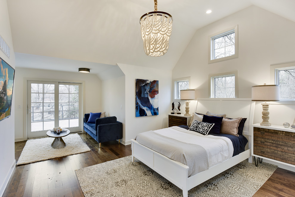 This is an example of a large contemporary master bedroom in Chicago with white walls, dark hardwood flooring, no fireplace and brown floors.