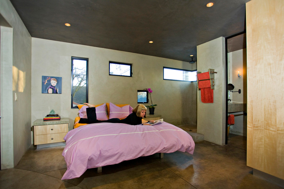 Photo of an urban bedroom in Sacramento with concrete flooring.