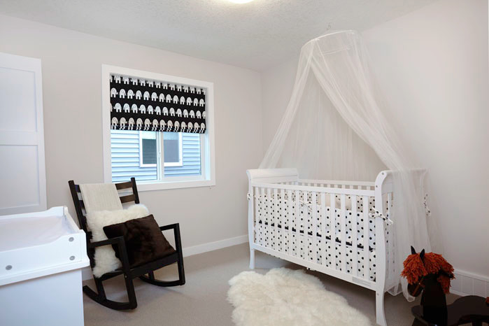 Mid-sized elegant carpeted nursery photo in Calgary with white walls