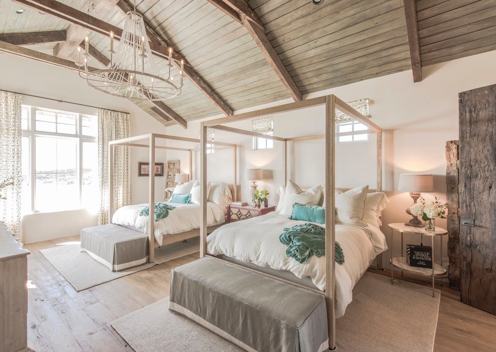 Inspiration for a rural guest bedroom in Austin with white walls and light hardwood flooring.
