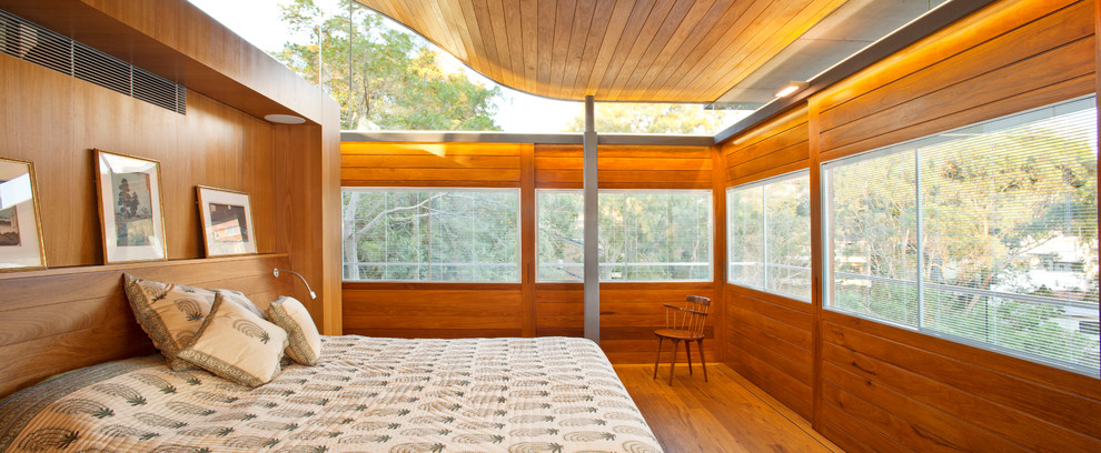 Medium sized contemporary master bedroom in Sydney with medium hardwood flooring.