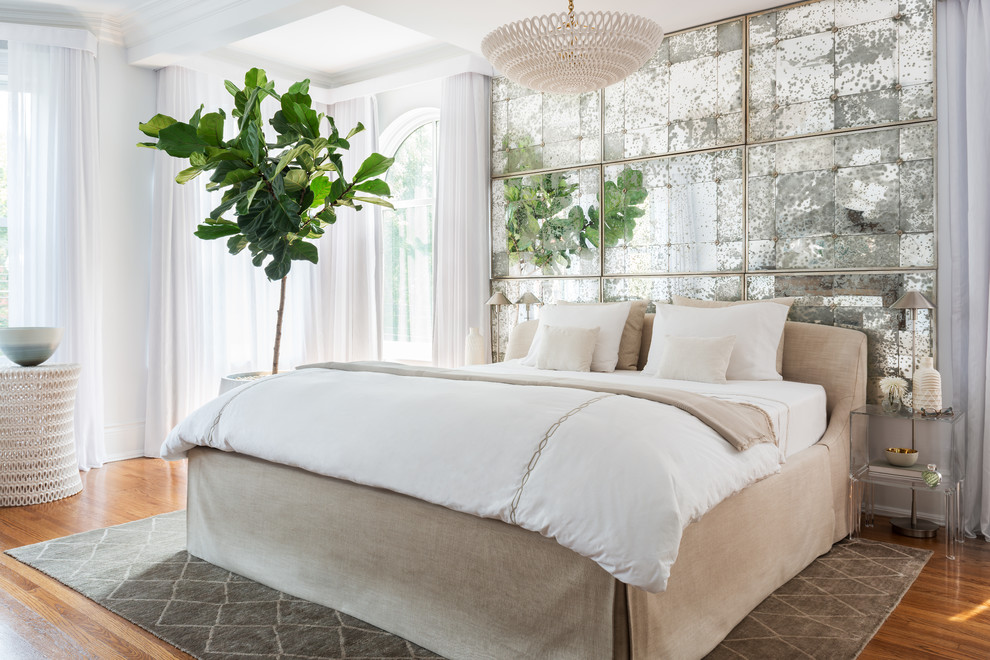 Inspiration for a large transitional master light wood floor bedroom remodel in Toronto with white walls, a standard fireplace and a tile fireplace