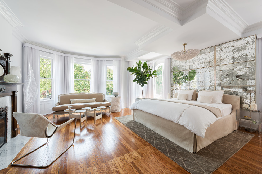 Large traditional master bedroom in Toronto with white walls, a standard fireplace, a stone fireplace surround, medium hardwood flooring and brown floors.