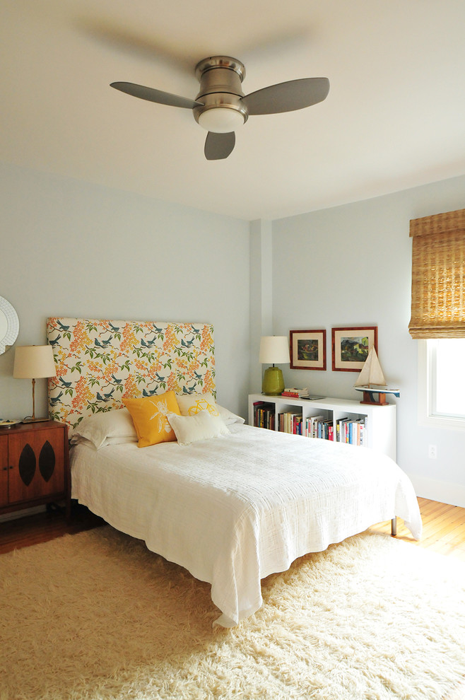 Photo of an eclectic bedroom in DC Metro with blue walls.