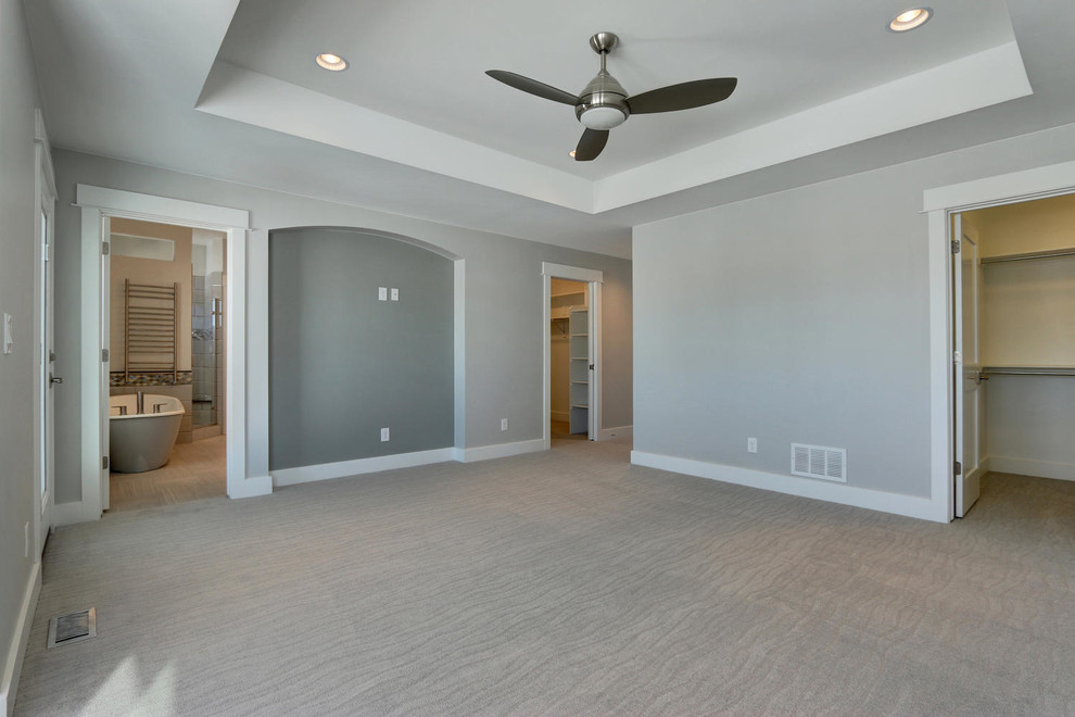 Inspiration for a large craftsman master carpeted bedroom remodel in Denver with gray walls
