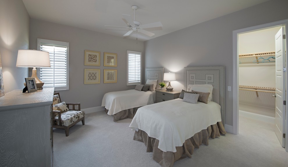 Example of a large tuscan carpeted and beige floor bedroom design in Miami with gray walls