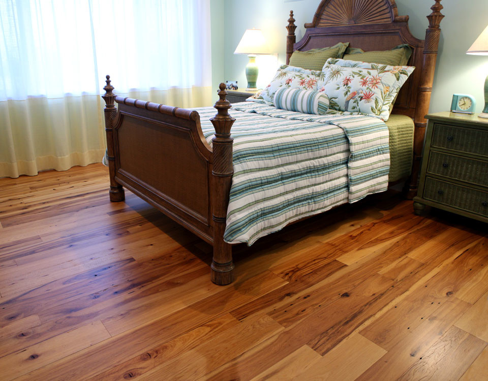Example of a classic medium tone wood floor and brown floor bedroom design in Cleveland with blue walls and no fireplace