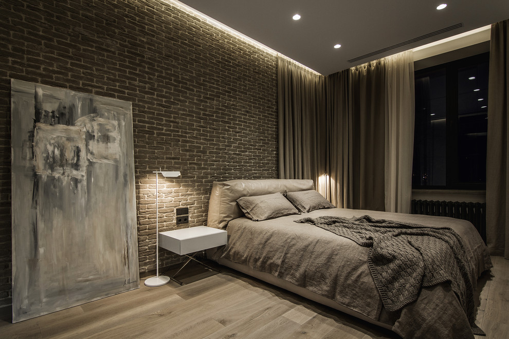 Photo of a contemporary bedroom in Seattle with light hardwood flooring.