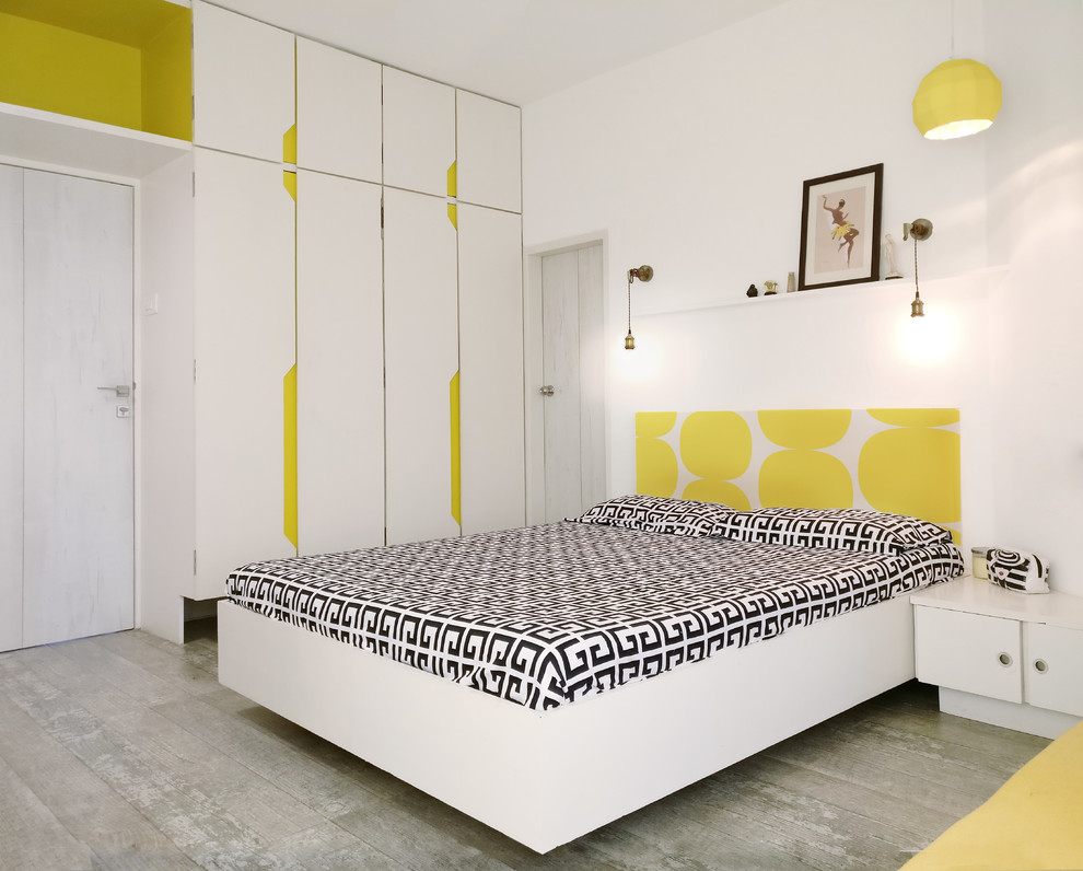 Example of a trendy bedroom design in Mumbai with white walls
