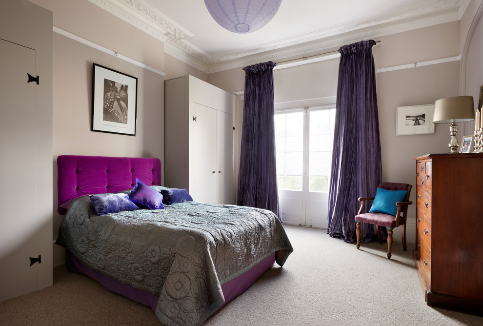 Eclectic master bedroom in Kent with grey walls, carpet and no fireplace.