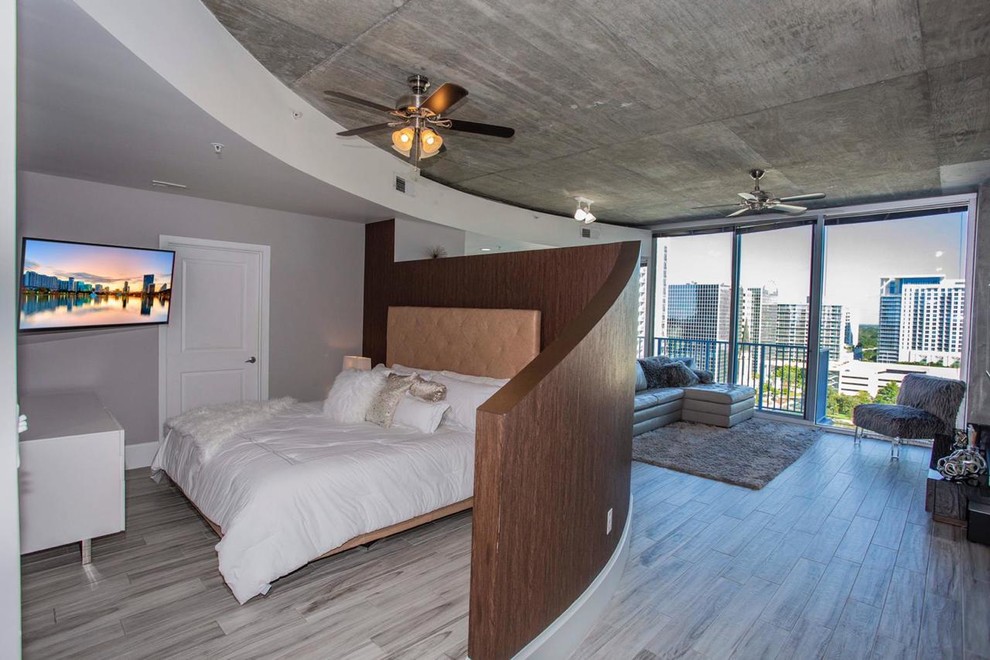 Inspiration for a mid-sized modern master laminate floor and gray floor bedroom remodel in Orlando with gray walls and no fireplace