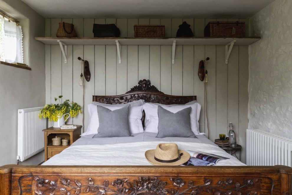 Inspiration for a small farmhouse guest bedroom remodel in Other with white walls