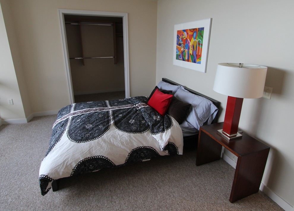 Example of a small minimalist master carpeted bedroom design in Portland with beige walls