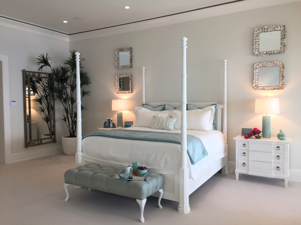 Example of a large beach style master carpeted and beige floor bedroom design in Tampa with white walls