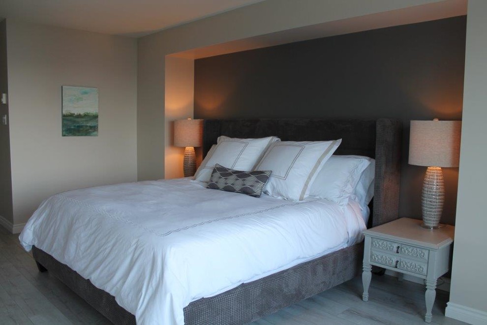 Medium sized contemporary master bedroom in Vancouver with grey walls and painted wood flooring.