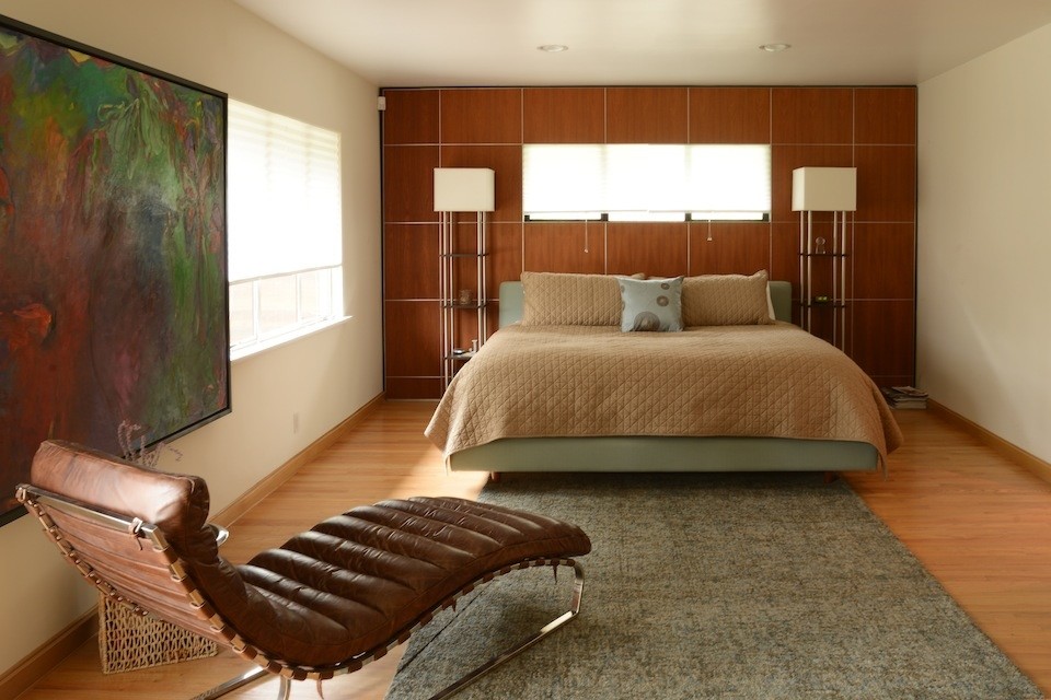 Inspiration for a contemporary master bedroom in Los Angeles with white walls and light hardwood flooring.