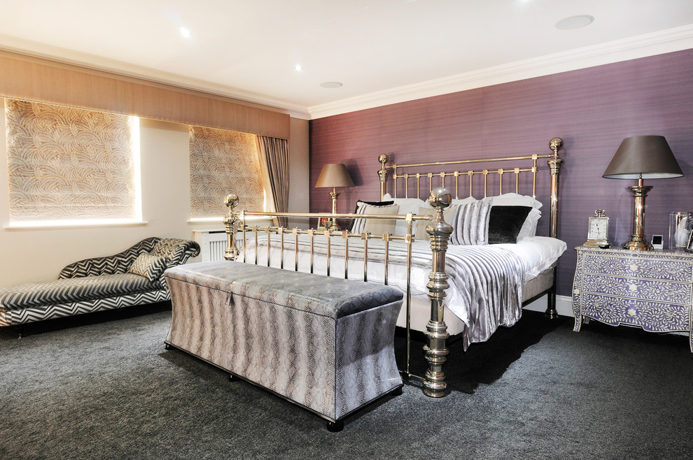 Expansive bohemian master bedroom in Essex with purple walls and carpet.