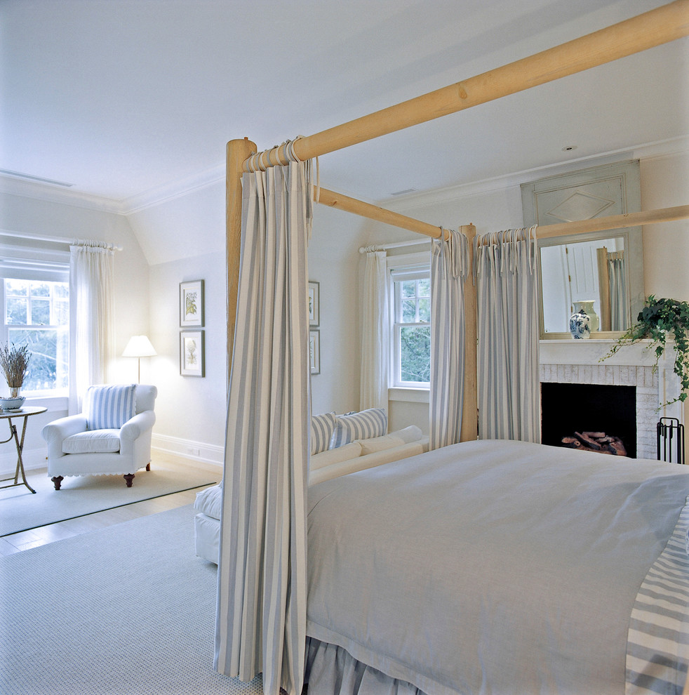 Bedroom - huge traditional guest carpeted bedroom idea in New York with white walls, a standard fireplace and a brick fireplace