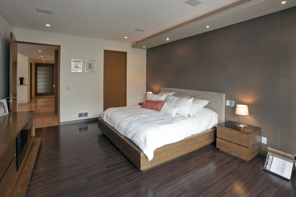 Contemporary bedroom with brown walls and dark hardwood flooring.