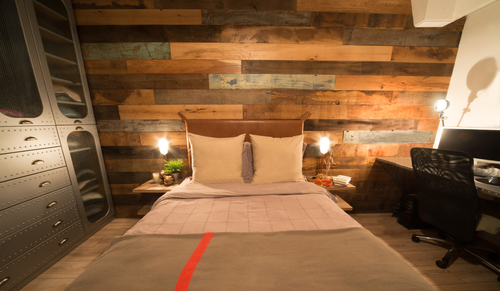 Inspiration for a mid-sized industrial master light wood floor bedroom remodel in Other with white walls
