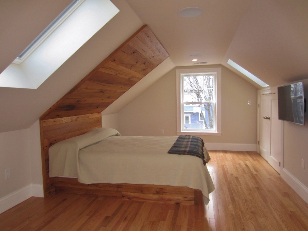 Design ideas for a small contemporary master bedroom in Boston with beige walls and light hardwood flooring.