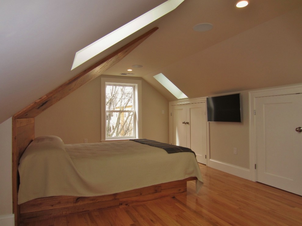 Inspiration for a small contemporary master bedroom in Boston with beige walls and light hardwood flooring.