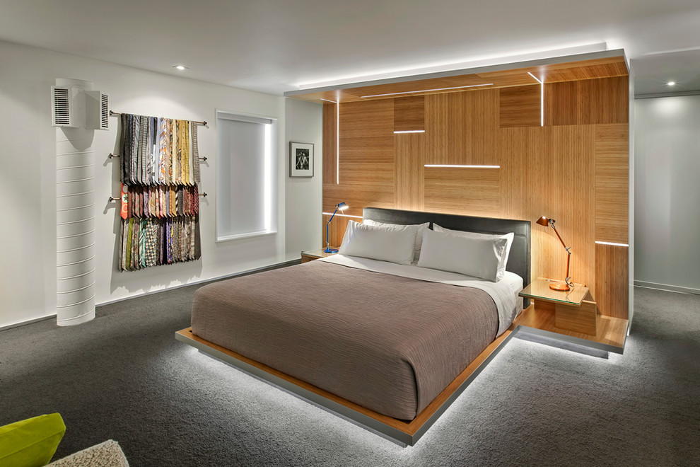 This is an example of a contemporary bedroom in Toronto with white walls, carpet and no fireplace.