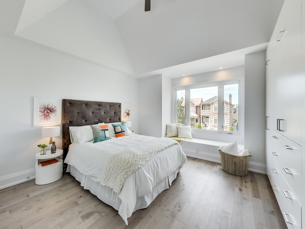 Mid-sized danish master light wood floor bedroom photo in Toronto with white walls and no fireplace