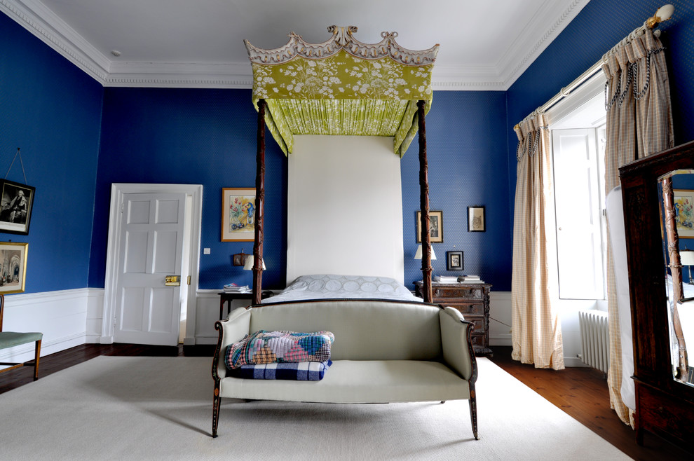 Example of a large classic guest dark wood floor bedroom design in Edinburgh with blue walls